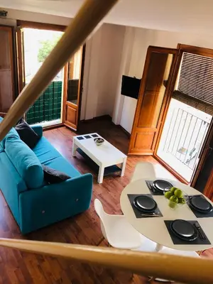a living room with a blue couch and a table at 123rooms in Valencia