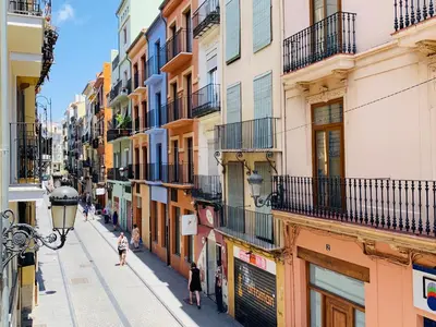 a street in a city with people walking down the street at 123rooms in Valencia