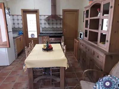 a kitchen with a table with a table cloth on it at CASITA RUSTICA DE INVITADOS (NEXT TO XATIVA) in Sellent