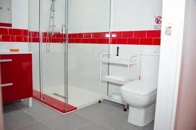 a bathroom with a toilet and a glass shower at Soraya's Place - Chopín 3 in Valencia