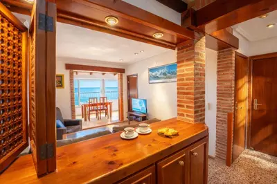a living room with a view of the ocean at Apartamento en primera línea de playa con vistas al mar in Mareny Barraquetas