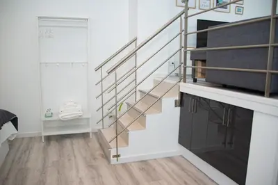 a staircase in a room with white walls and wooden floors at Soraya's Place - Chopín 4 in Valencia