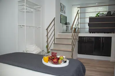 a room with a bowl of fruit on a bed at Soraya's Place - Chopín 4 in Valencia