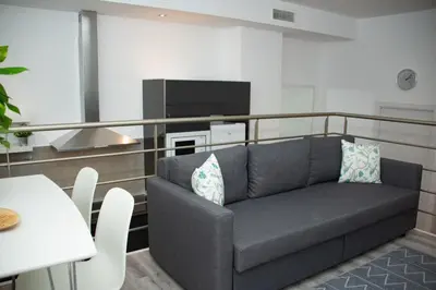 a living room with a couch and a flat screen tv at Soraya's Place - Chopín 4 in Valencia