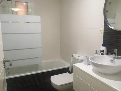 a bathroom with a sink and a toilet and a tub at Apartamento nuevo playa de Canet de Berenguer WIFI in Canet de Berenguer