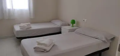 a room with two beds with towels on them at Apartamento nuevo playa de Canet de Berenguer WIFI in Canet de Berenguer