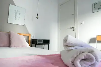 a bedroom with a bed with a towel on it at Torres de Serrano Apartment in Valencia