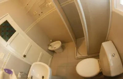 a small bathroom with two toilets and a sink at apartemento ideal familia y grupo climatisacion playa poblaA in Valencia