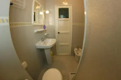 a small bathroom with a toilet and a sink at apartemento ideal familia y grupo climatisacion playa poblaA in Valencia