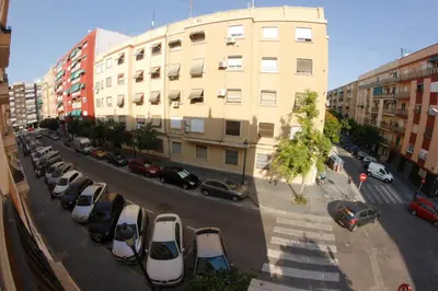 a parking lot with cars parked in front of a building at apartemento ideal familia y grupo climatisacion playa poblaA in Valencia