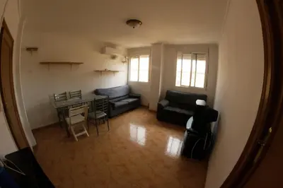 a living room with a couch and a table at apartemento ideal grupo y familia climatisacion y cerca playa . mongrell in Valencia