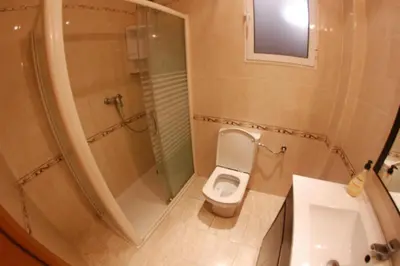 a small bathroom with a toilet and a shower at apartemento ideal grupo y familia climatisacion y cerca playa . mongrell in Valencia