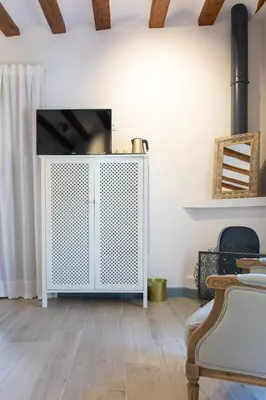 a living room with a tv on a white cabinet at Los Canilleros in Requena
