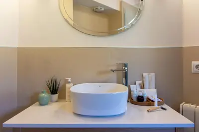 a bathroom with a sink and a mirror on a counter at Los Canilleros in Requena