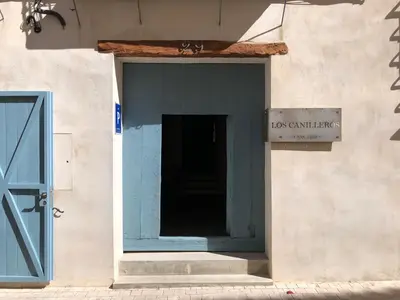 a door to a building with a sign on it at Los Canilleros in Requena