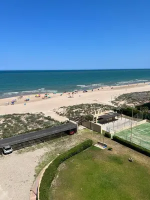a view of a beach with people on the sand at Apartamento de playa Valmar - Beachfront exclusive residential in El Perellonet