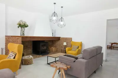 a living room with a couch and chairs and a fireplace at Villa Conchin Casa junto a Parque Natural in Alberique