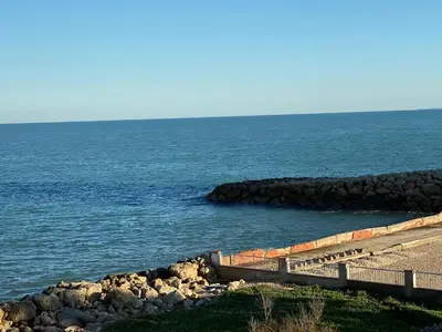 a path leading to the ocean with rocks in the water at 1era linea de playa VILLA MARGARET Cullera Marenyet in Cullera