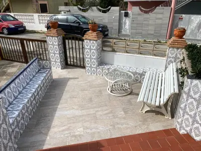 a group of benches on a patio with a fence at 1era linea de playa VILLA MARGARET Cullera Marenyet in Cullera