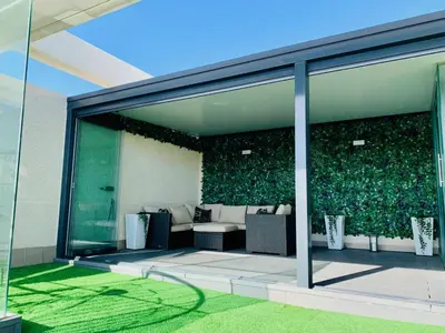 a glass extension of a building with a green wall at NON STRESS Ático Dúplex con vistas al MAR in Valencia