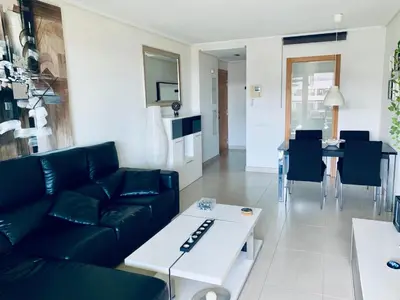 a living room with a couch and a table at NON STRESS Ático Dúplex con vistas al MAR in Valencia
