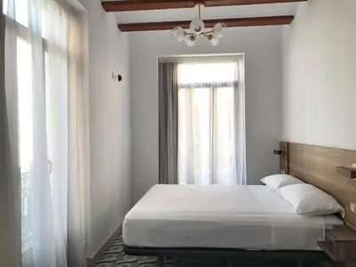 a white bedroom with a bed and a window at Hotel 19-30 Valencia in Valencia