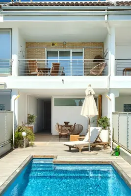 a villa with a swimming pool and a house at Casa frente al mar con piscina privada in Sagunto