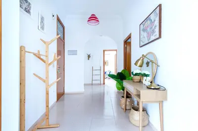 a hallway with white walls and a wooden desk at Design, beach and city center in Valencia