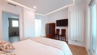 a white bedroom with a bed and a table at Valencia Town Hall Dream in Valencia