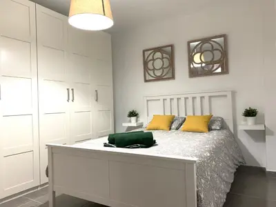a white bedroom with a bed with yellow pillows at UIM Mediterraneo PB Segorbe Wifi in Puerto de Sagunto