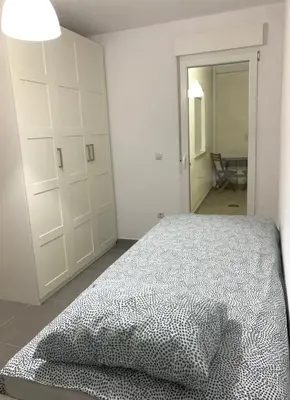 a bedroom with a bed and a large closet at UIM Mediterraneo PB Segorbe Wifi in Puerto de Sagunto