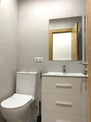 a bathroom with a toilet and a sink and a mirror at UIM Mediterraneo PB Segorbe Wifi in Puerto de Sagunto