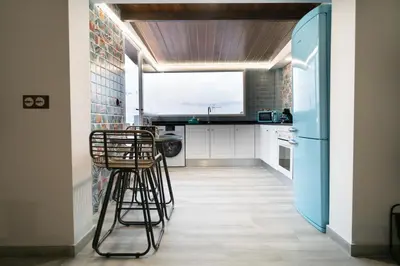 a kitchen with two stools and a refrigerator at Bellanna - Panorámica in Anna