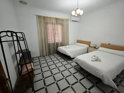 two beds in a room with a tiled floor at Casa MarTa in Chella