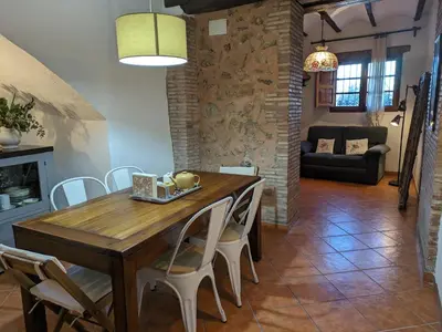 a kitchen and dining room with a wooden table and chairs at Ca'n Josep in Segorbe