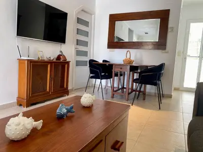 a living room with a table and a dining room at Ideal house at the Beach in Sagunto(Valencia) in Sagunto