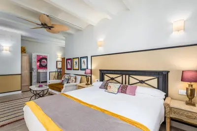 a bedroom with a large bed and a couch at Maison San Alfredo B&B in El Puig