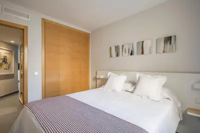 a bedroom with a large bed with white sheets and pillows at Stancia Carmen in Valencia