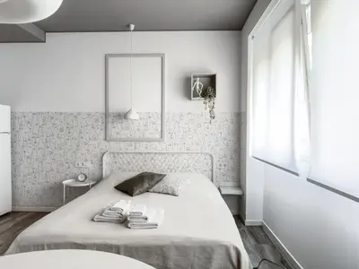 a white bedroom with a bed with towels on it at Budget Inn in Valencia