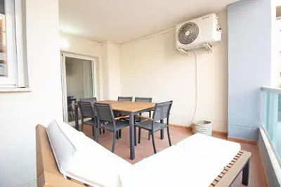 a dining room with a table and chairs at Global Vacacional, Apartamento en la playa de Canet d'en Berenguer in Canet de Berenguer