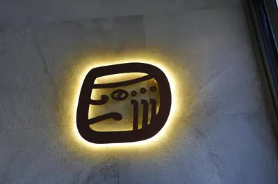 a neon sign on a wall with a video game controller at Hotel Loob Valencia in Mislata