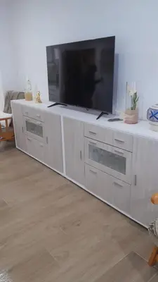 a white entertainment center with a flat screen tv on it at 150m2 Con vistas al Mar y al Castillo de Cullera in Cullera