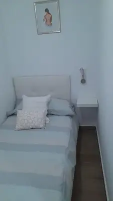 a white bed in a room with a picture on the wall at 150m2 Con vistas al Mar y al Castillo de Cullera in Cullera