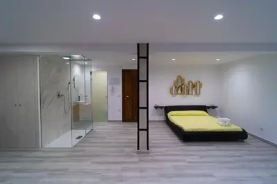 a bedroom with a yellow bed and a shower at Sensaciones in Anna