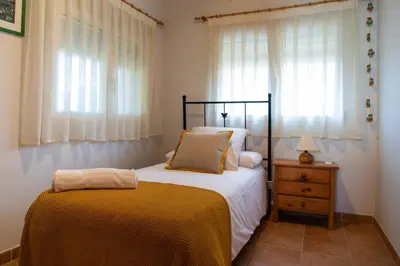 a bedroom with a bed and a dresser and window at FLORIT FLATS - The Orange Lemon Tree House in La Eliana