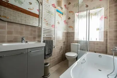 a bathroom with a tub and a toilet and a sink at Boutique House Alzira in Alzira