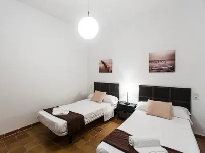two beds in a room with white walls at Total Valencia Charming in Valencia