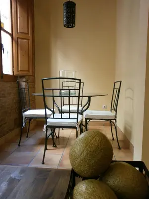 a dining room with a table and four chairs at Total Valencia Charming in Valencia