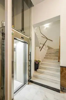 a staircase in a house with a glass door at Mon Suites Benlliure in Valencia