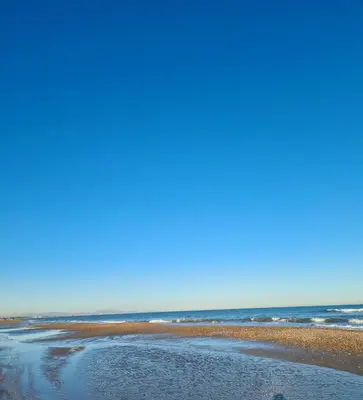 a sandy beach with the ocean in the background at Casa Coqueta in Almarda